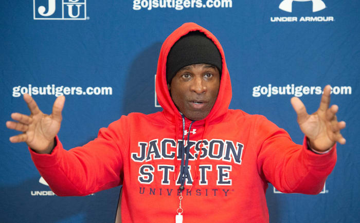 Deion Sanders speaks at a press conference.